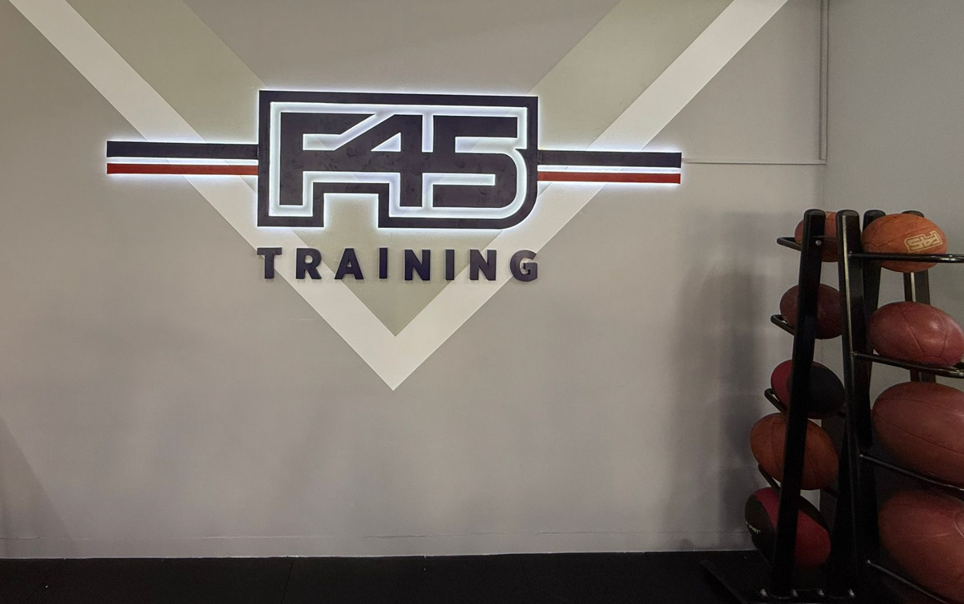 F45 Training logo on a wall with exercise balls in the background